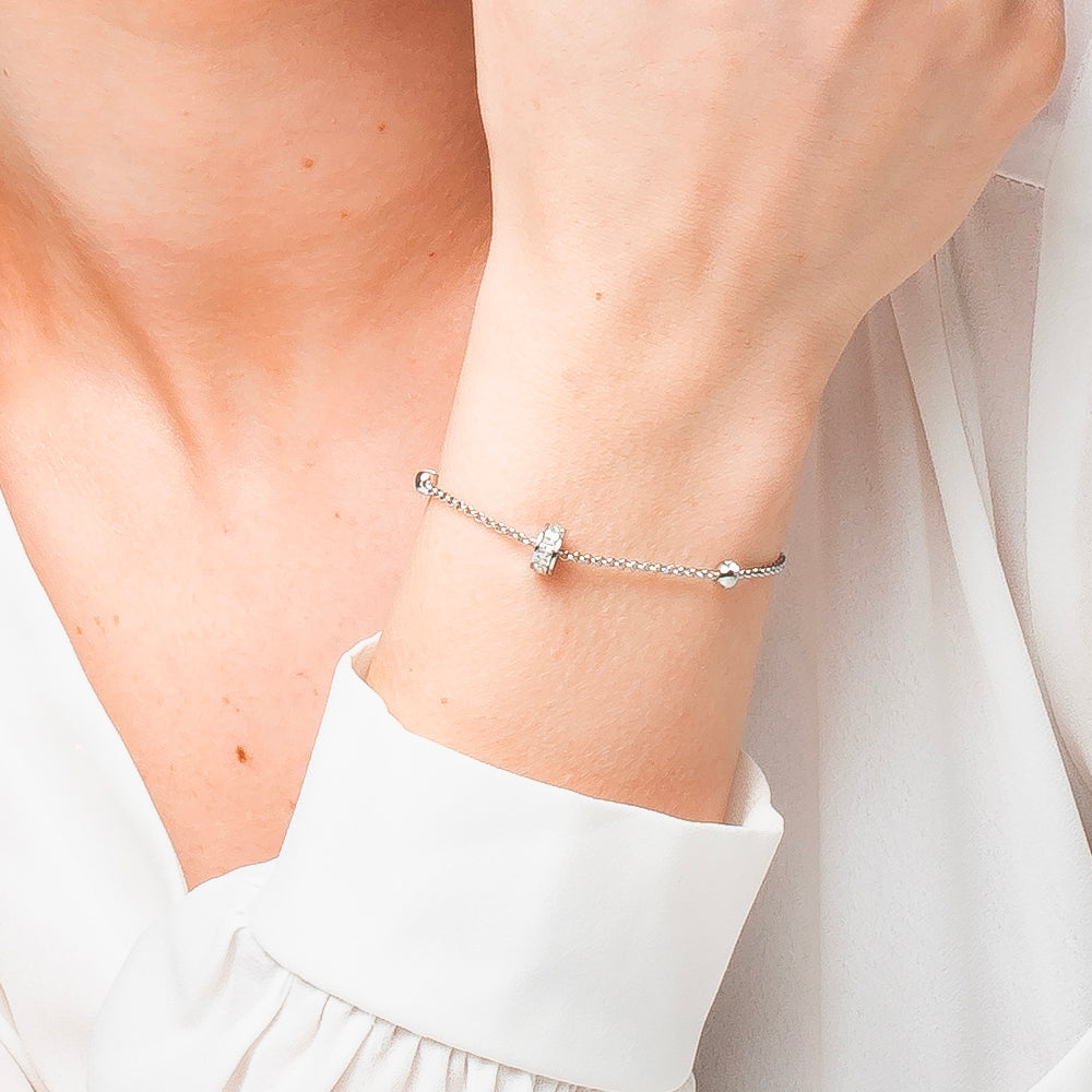 BRACCIALE DONNA IN ACCIAIO, BUSSOLOTTO ED ELEMENTI CON ZIRCONI BIANCHI