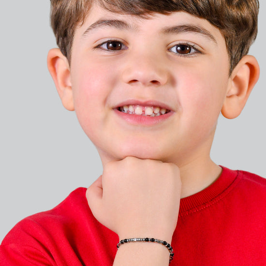 BRACCIALE BAMBINO IN ACCIAIO CON PIETRE NERE E GRIGIE